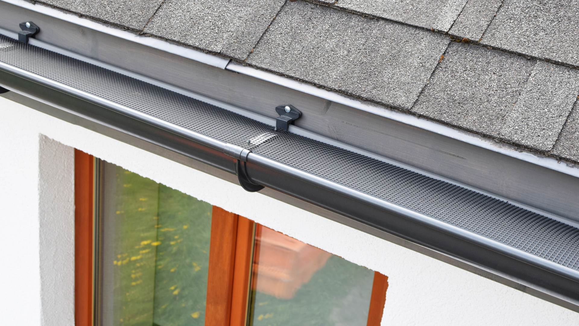 seamless gutter installation close up of black gutters